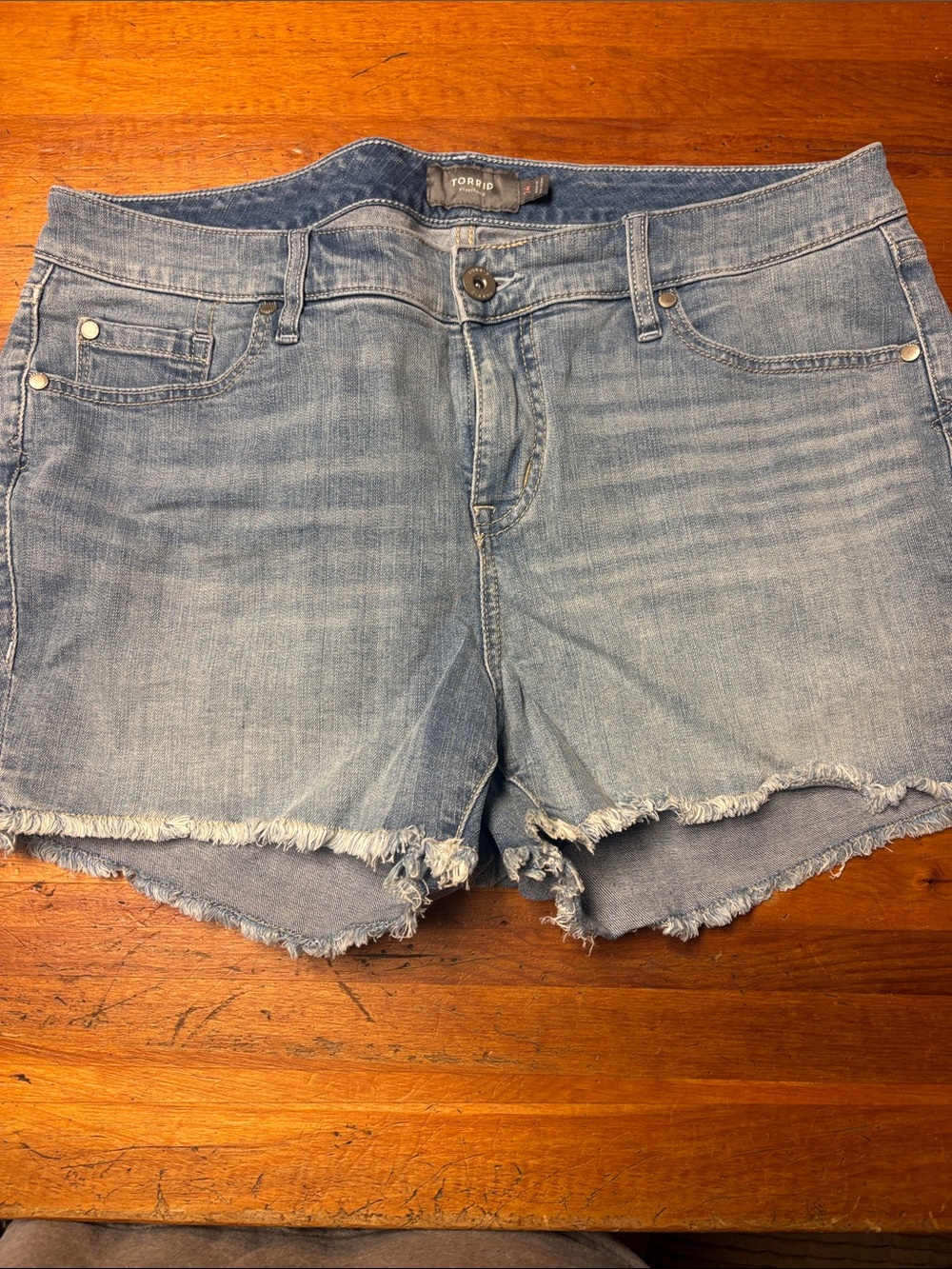 torrid light wash denim cutoff shorts with frayed hem